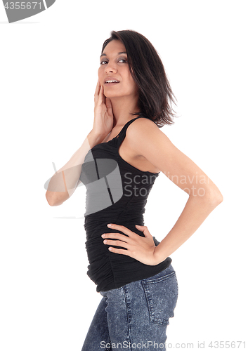 Image of Hispanic woman standing in profile.