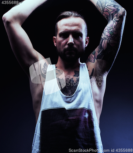 Image of A man with tattooes on his arms. Silhouette of muscular body. ca