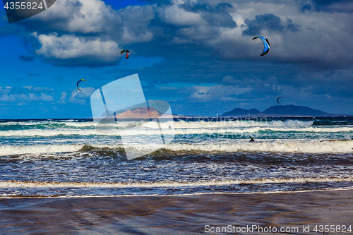 Image of Surfers and kiters in the water on Famara beach, Lanzarote