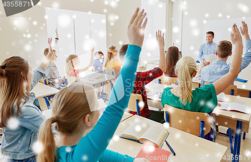 Image of group of students and teacher with papers or tests