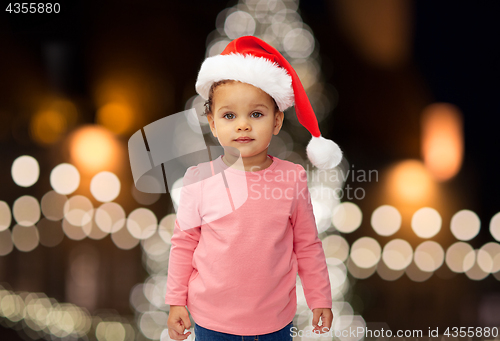 Image of little baby girl in santa hat at christmas