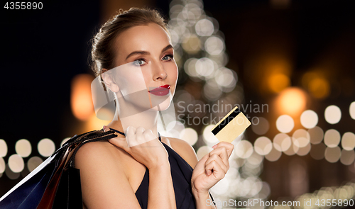 Image of woman with credit card and shopping bags