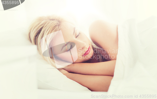 Image of young woman sleeping in bed at home bedroom