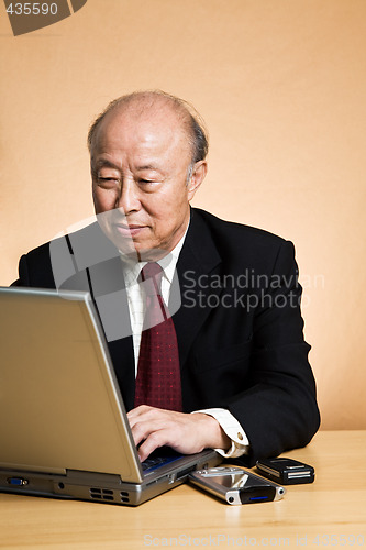 Image of Working asian businessman