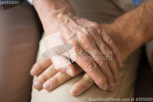 Image of close up of senior couple holding hands