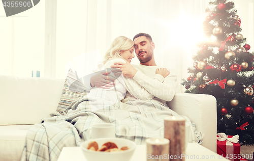 Image of happy couple at home with christmas tree