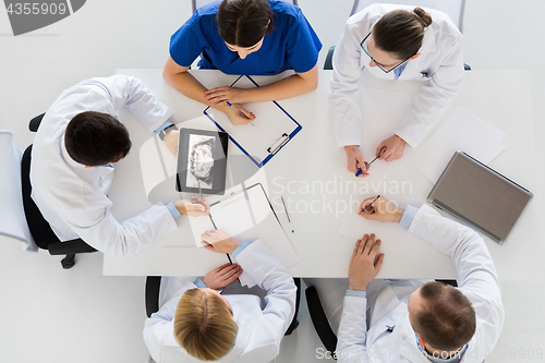 Image of doctors with jaw x-ray on tablet pc at clinic