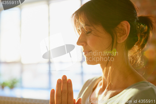 Image of close up of yogi woman meditating at yoga studio