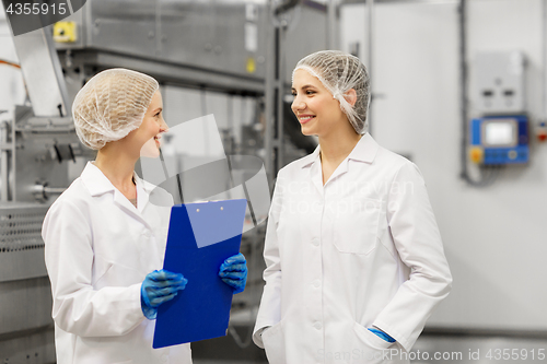 Image of happy women technologists at ice cream factory