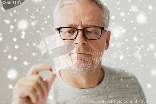 Image of close up of senior man taking medicine pill