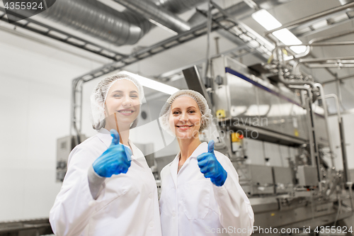 Image of happy women technologists at ice cream factory