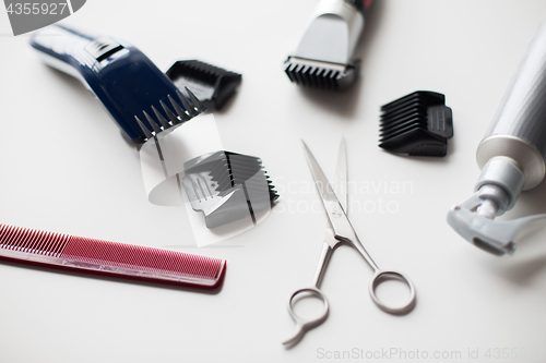 Image of styling hair sprays, clippers, comb and scissors