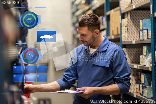 Image of auto mechanic with clipboard at car workshop