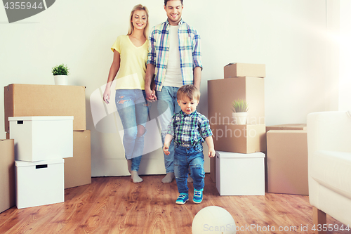 Image of happy family moving to new home and playing ball