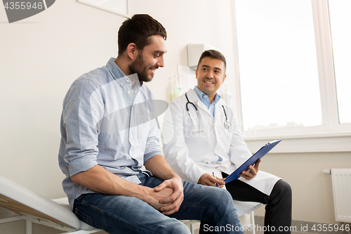 Image of smiling doctor and young man meeting at hospital