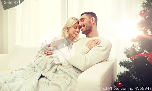 Image of happy couple at home with christmas tree