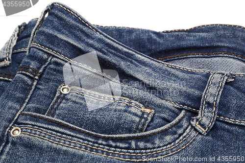 Image of Fragment of dark blue jeans on white background