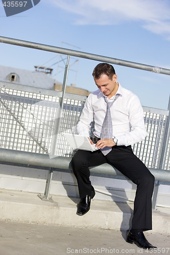 Image of handsome businessman with laptop
