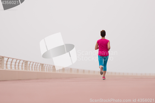 Image of woman busy running on the promenade