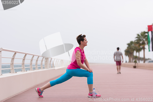 Image of woman stretching and warming up on the promenade