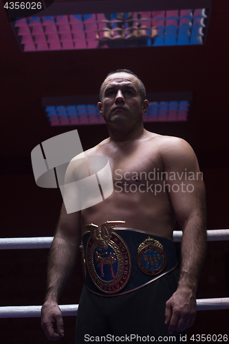 Image of kick boxer with his championship belt