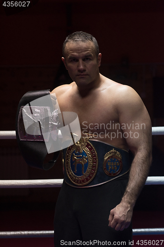 Image of kick boxer with his championship belt