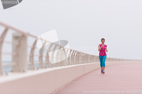 Image of woman busy running on the promenade