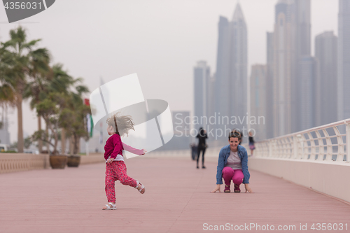 Image of mother and cute little girl on the promenade