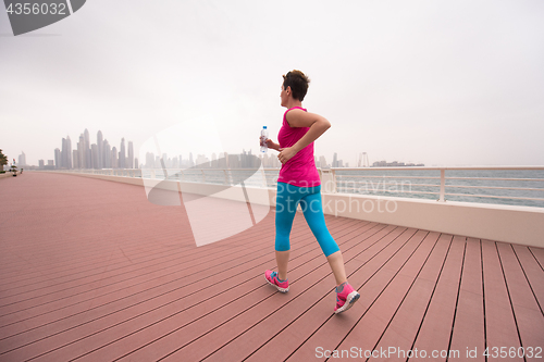 Image of woman running on the promenade