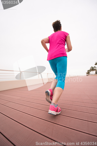 Image of woman busy running on the promenade