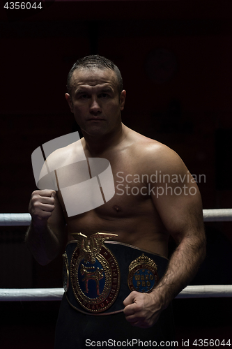 Image of kick boxer with his championship belt