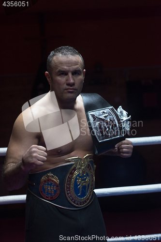 Image of kick boxer with his championship belt