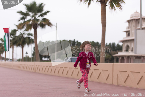 Image of cute little girl on the promenade by the sea