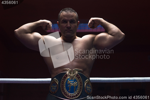 Image of kick boxer with his championship belt