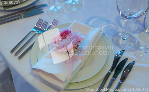 Image of Spring table settings with fresh flower, napkin and silverware. Holidays background. Selective Focus.