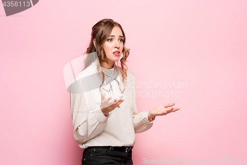 Image of Portrait of young woman with shocked facial expression