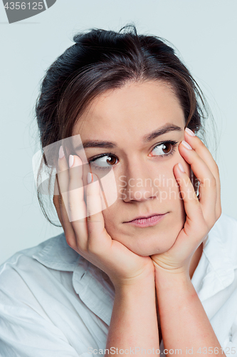 Image of The young woman\'s portrait with thoughtful emotions