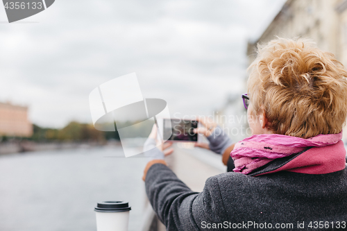 Image of Woman taking shots from waterfront