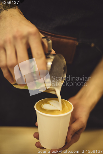Image of Bartender pouring coffee to cup