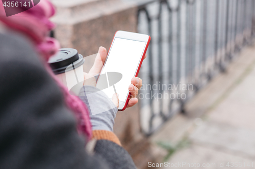 Image of Woman using smartphone at river