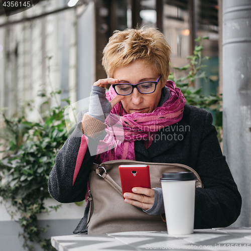 Image of Adult woman surfing phone