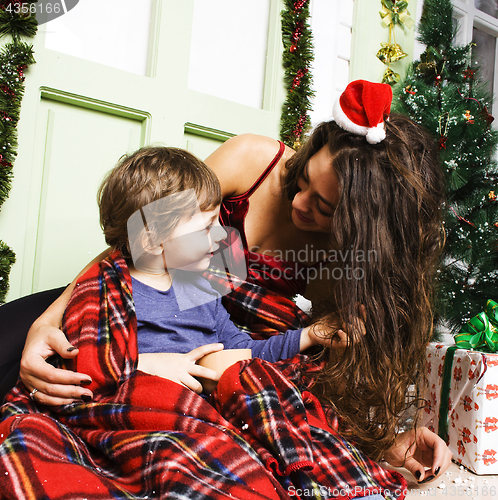 Image of happy smiling family on Christmas at house with gifts, young mot