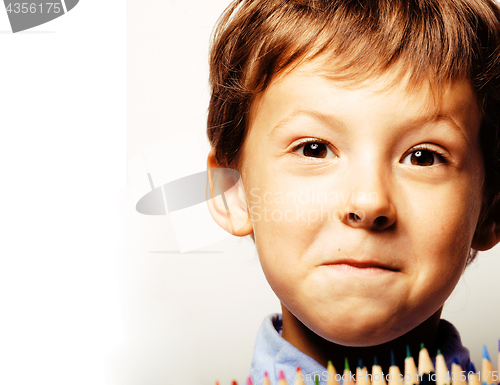 Image of little cute boy with color pencils close up smiling, education f