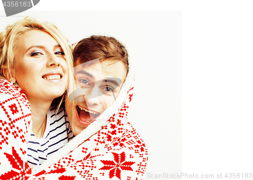 Image of young pretty teenage couple at Christmas time warming in red dec