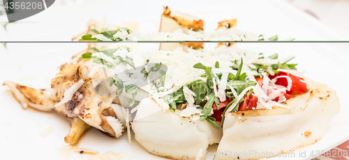 Image of Cuttlefish with tomato, salad and Parmigiano cheese