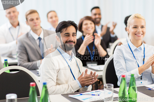 Image of people applauding at business conference