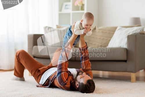 Image of happy father with little baby boy at home