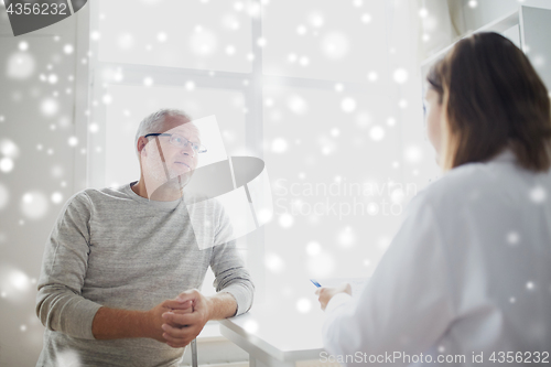 Image of senior man and doctor meeting at hospital