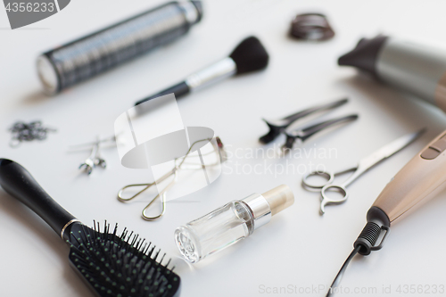 Image of hairdryer, scissors and other hair styling tools