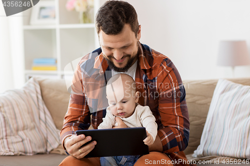 Image of happy father and baby boy with tablet pc at home